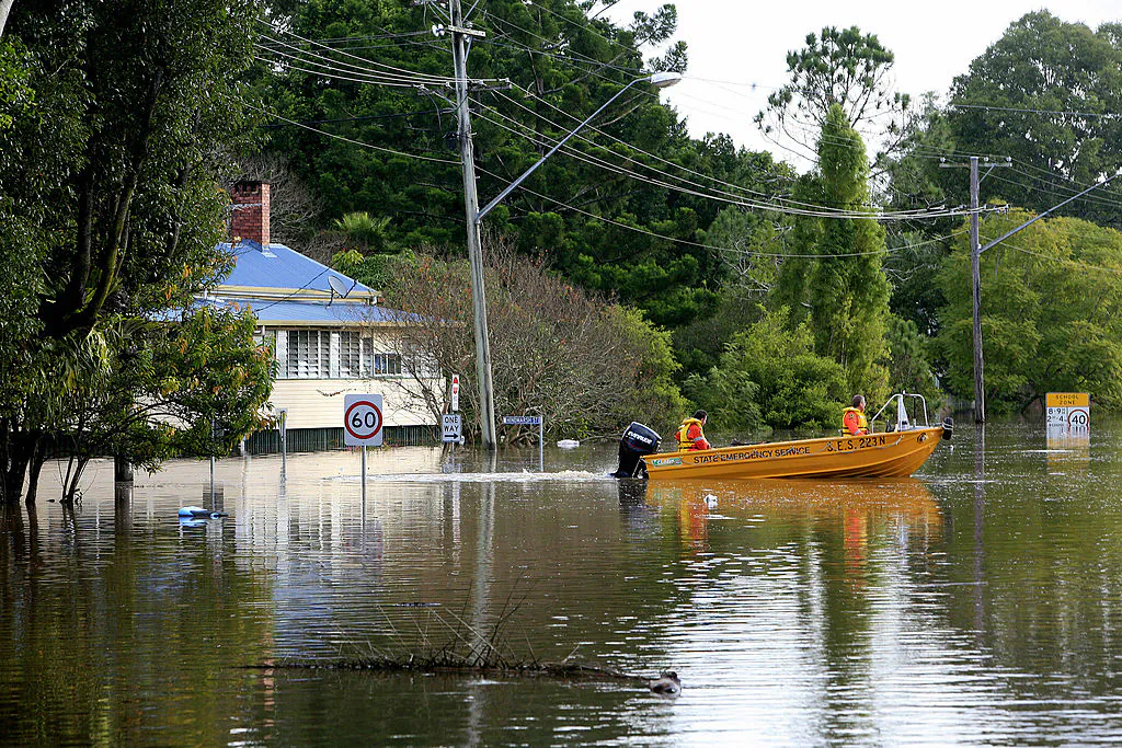 State Emergency Service staff patrol a flooded Brunswick Street in Lismore on May 22, 2009. (EDDIE SAFARIK/AFP via Getty Images)