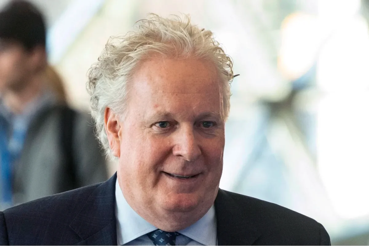 Jean Charest speaks walks through the halls at the Canadian Aerospace Summit in Ottawa on Nov. 13, 2019. (The Canadian Press/Adrian Wyld)