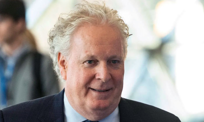 Jean Charest speaks walks through the halls at the Canadian Aerospace Summit in Ottawa on Nov. 13, 2019. (The Canadian Press/Adrian Wyld)
