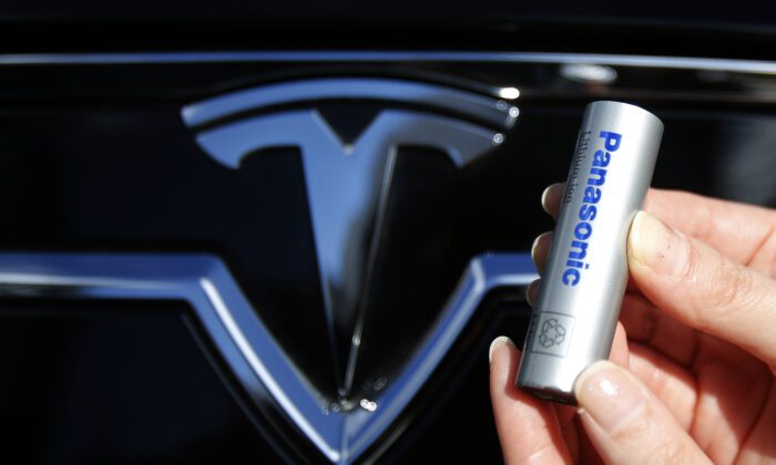 A Panasonic Corp.'s lithium-ion battery, which is part of Tesla Motor Inc.'s Model S and Model X battery packs, is pictured with Tesla Motors logo at the Panasonic Center in Tokyo, on Nov. 19, 2013. (Yuya Shino/Reuters)