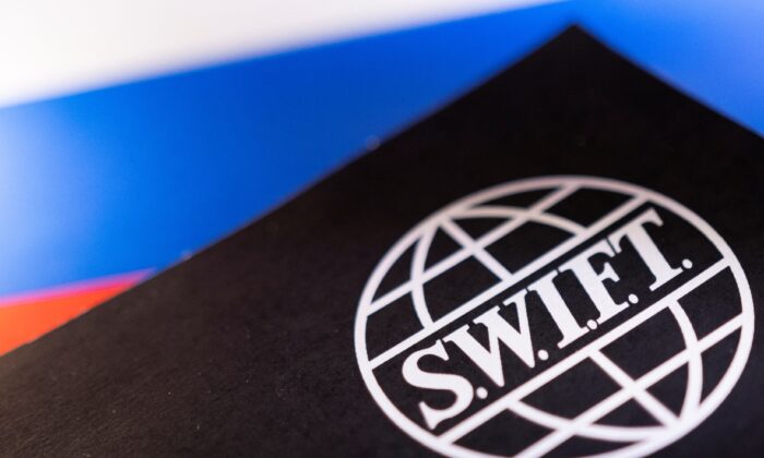 Swift logo is placed on a Russian flag in an illustration on Feb. 25, 2022. (Dado Ruvic/Reuters)