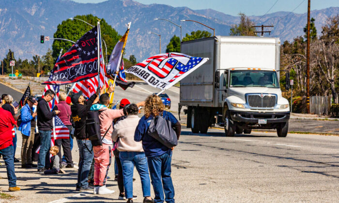 People gather in El Monte, Calif., to show support for truckers partaking in a convoy from Los Angeles to Washington, D.C., in protest of coronavirus mandates, on Feb. 25, 2022. (John Fredricks/The Epoch Times)