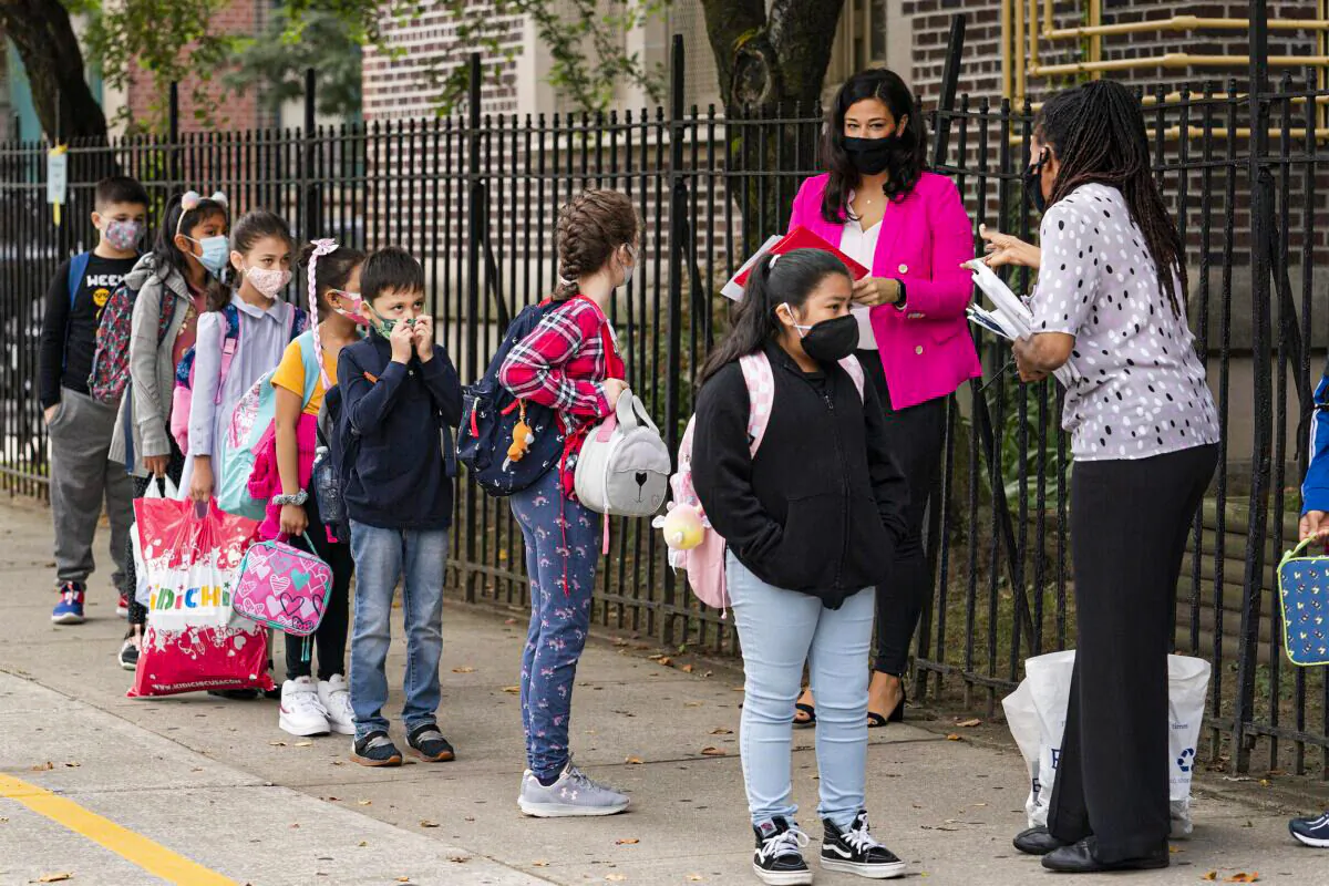 Teachers line up their students before entering PS 179 elementary school in the Kensington neighborhood, in the Brooklyn borough of New York, on Sept. 29, 2020. (Mark Lennihan/AP Photo)