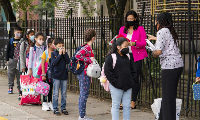 Teachers line up their students before entering PS 179 elementary school in the Kensington neighborhood, in the Brooklyn borough of New York, on Sept. 29, 2020. (Mark Lennihan/AP Photo)