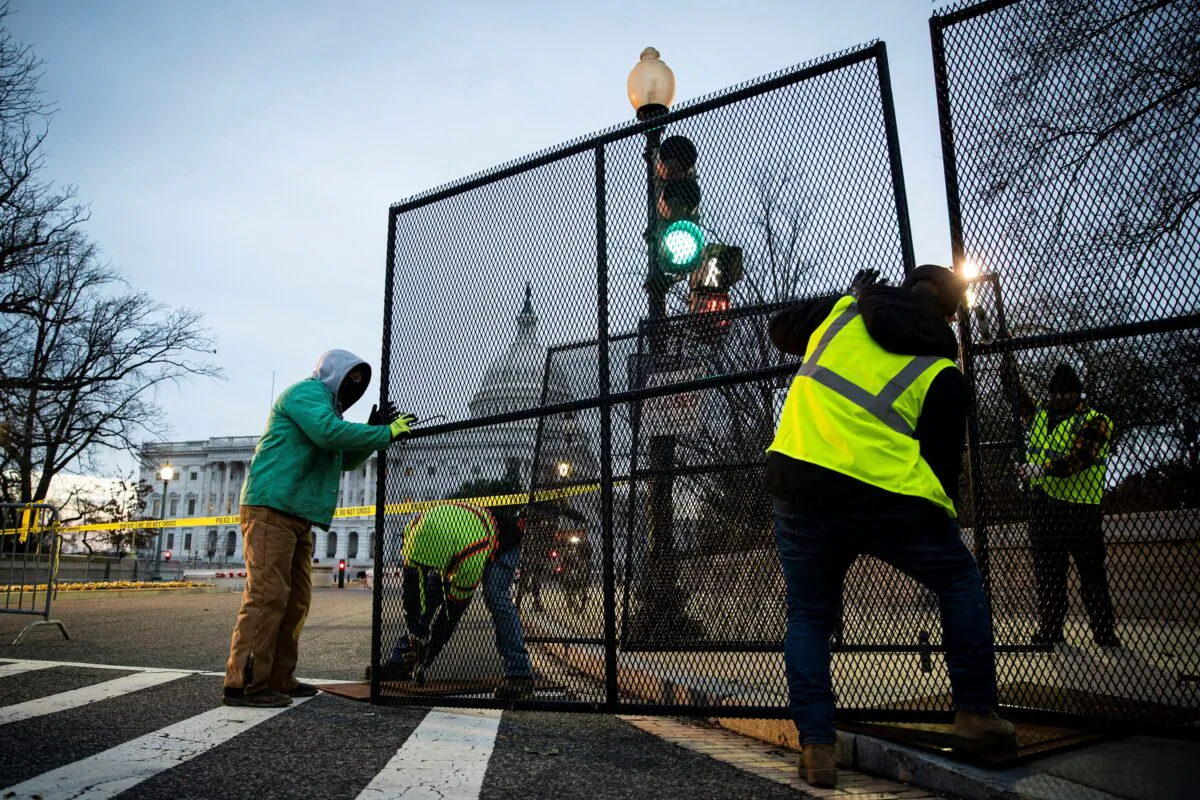 Workers install security fencing around the perimeter of the U.S. Capitol, ahead of the upcoming State of the Union with U.S. President Joe Biden on Feb. 27, 2022. (Al Drago/Reuters)