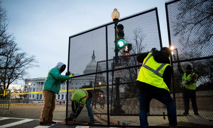 Workers install security fencing around the perimeter of the U.S. Capitol, ahead of the upcoming State of the Union with U.S. President Joe Biden on Feb. 27, 2022. (Al Drago/Reuters)