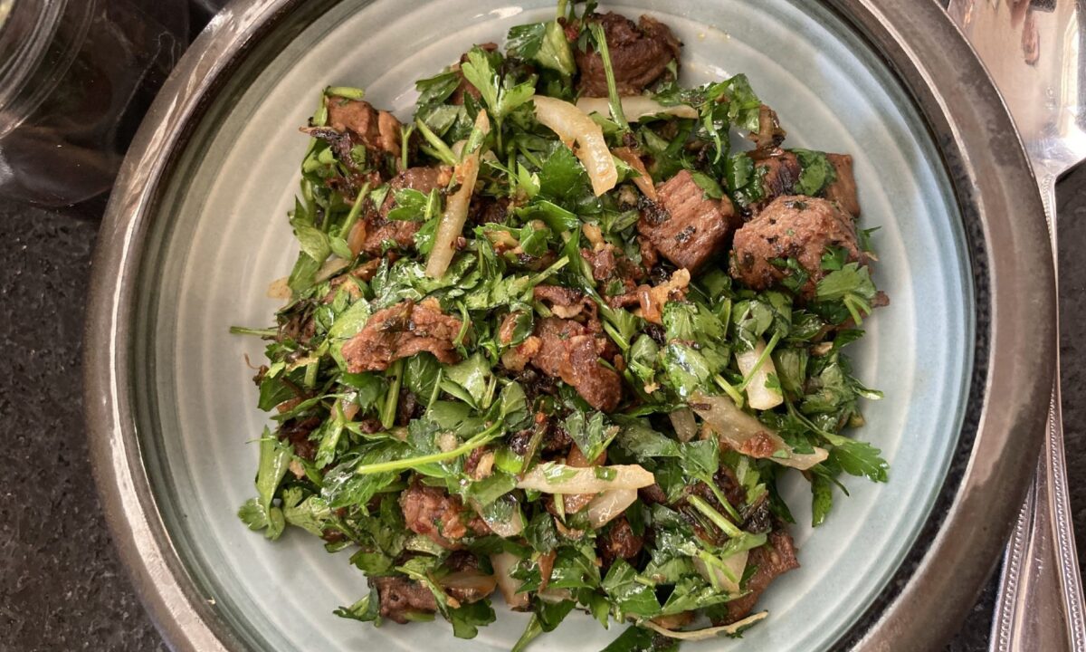 Garlic-fried wild game—or the closest to it you can find—completes this zingy herb salad. (Ari LeVaux)