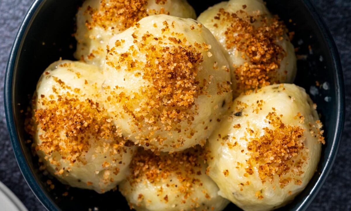 These comforting potato dumplings are seasoned with dried marjoram and topped with toasted breadcrumbs. (Eric Kleinberg/TNS)