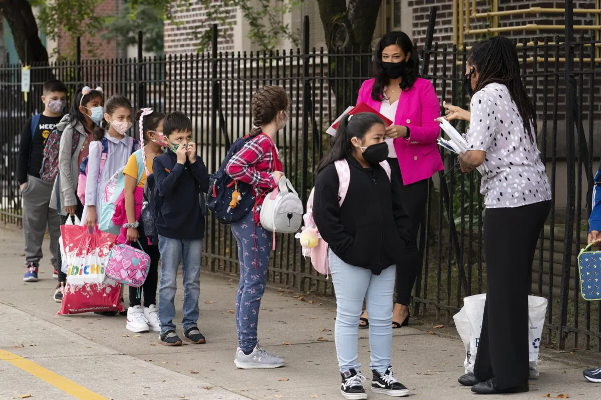 Teachers line up their students before entering PS 179 elementary school in New York City in a file image. (Mark Lennihan/AP Photo)