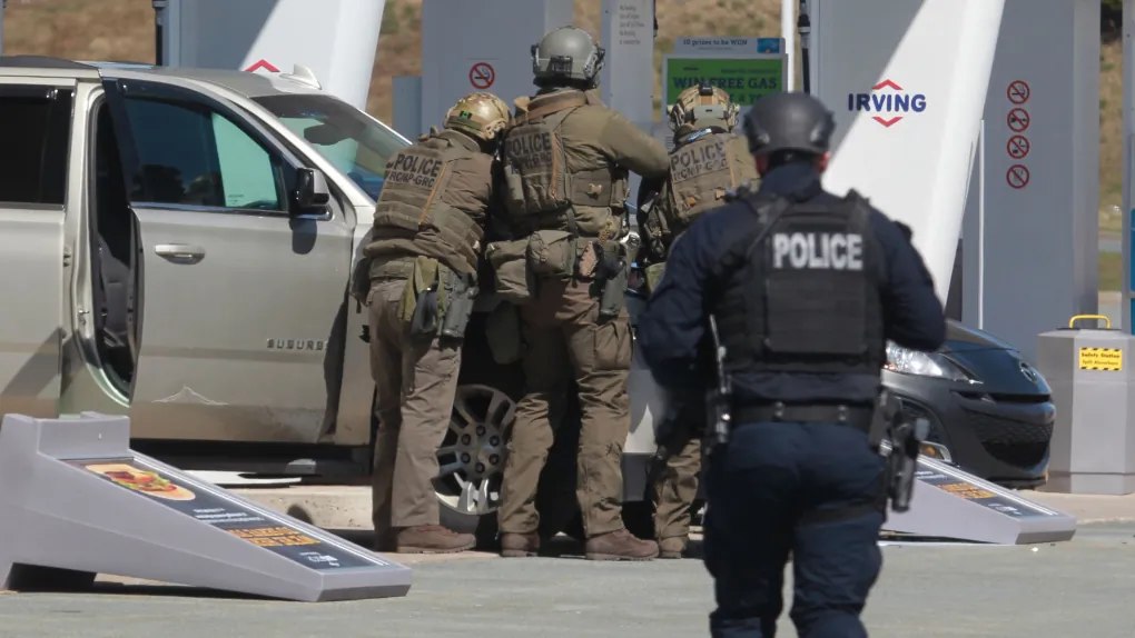 RCMP officers descend on a gas station in Enfield, N.S., where the gunman behind the mass killing was shot dead, on April 19, 2022. (The Canadian Press/Tim Krochak)