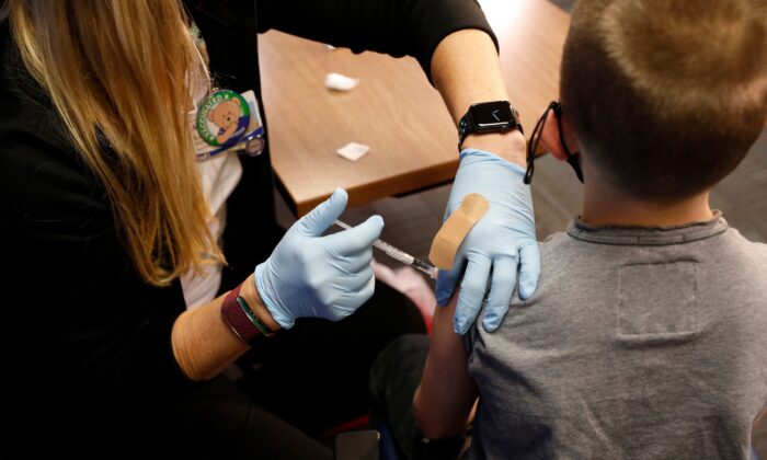 A 8 year-old child receives a dose of Pfizer's COVID-19 vaccine in Southfield, Mich., on Nov. 5, 2021. (Jeff Kowalsky/AFP via Getty Images)