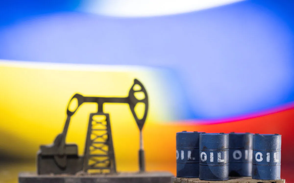 Models of oil barrels and a pump jack are displayed in front of Ukrainian and Russian flag colors in this illustration taken on Feb. 24, 2022. (Dado Ruvic/Reuters)