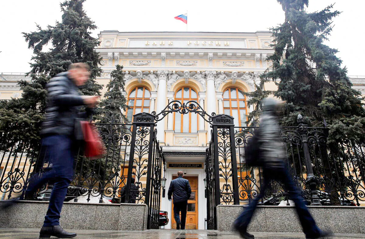 People walk past the Central Bank headquarters in Moscow, Russia, on Feb. 11, 2019. (Maxim Shemetov/Reuters)