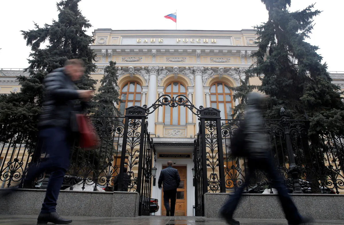 People walk past the Central Bank headquarters in Moscow, Russia, on Feb. 11, 2019. (Maxim Shemetov/Reuters)