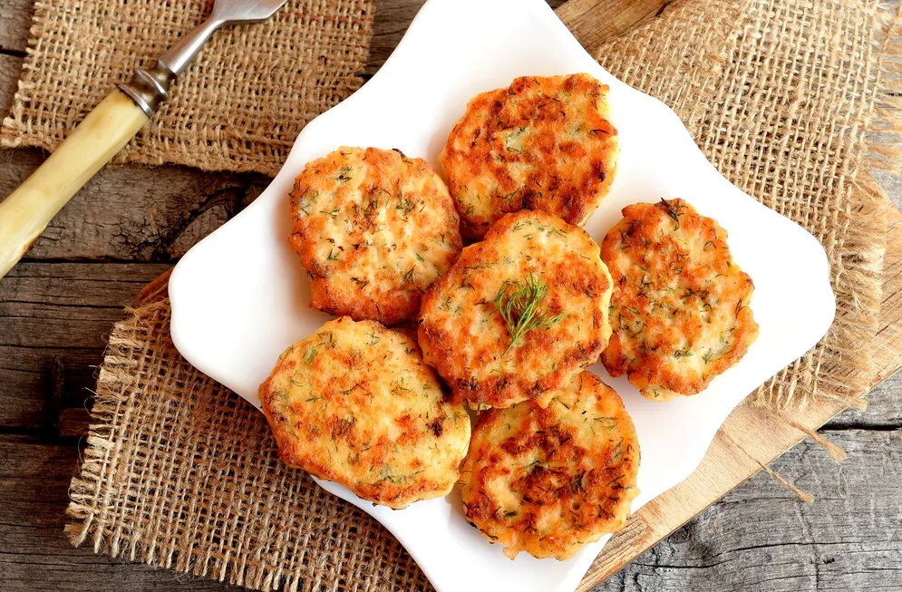 These fish cakes are packed with buttery-rich salmon, sweet shrimp, fresh herbs, and fiery bits of chile. (OnlyZoia/Shutterstock)