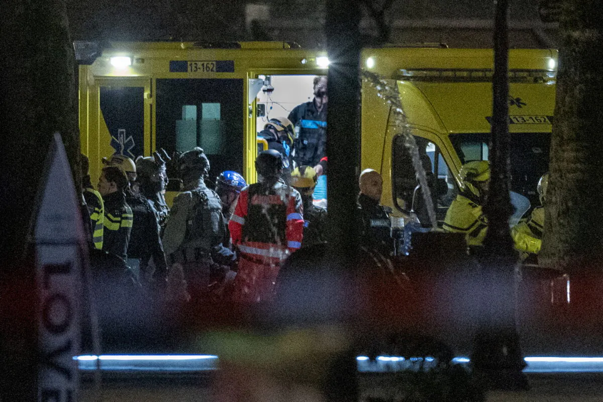 Police special intervention units and rescue workers are seen as the injured hostage taker is carried into an ambulance in Amsterdam, Netherlands, on Feb. 22, 2022. (Peter Dejong/AP Photo)