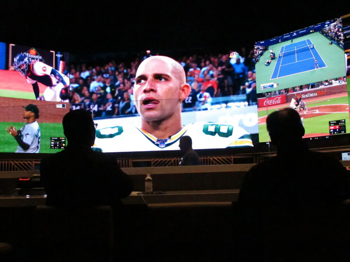 People watch video screens in the sports betting lounge at Bally's casino in Atlantic City, N.J., on Sept. 5, 2019. (AP Photo/Wayne Parry)