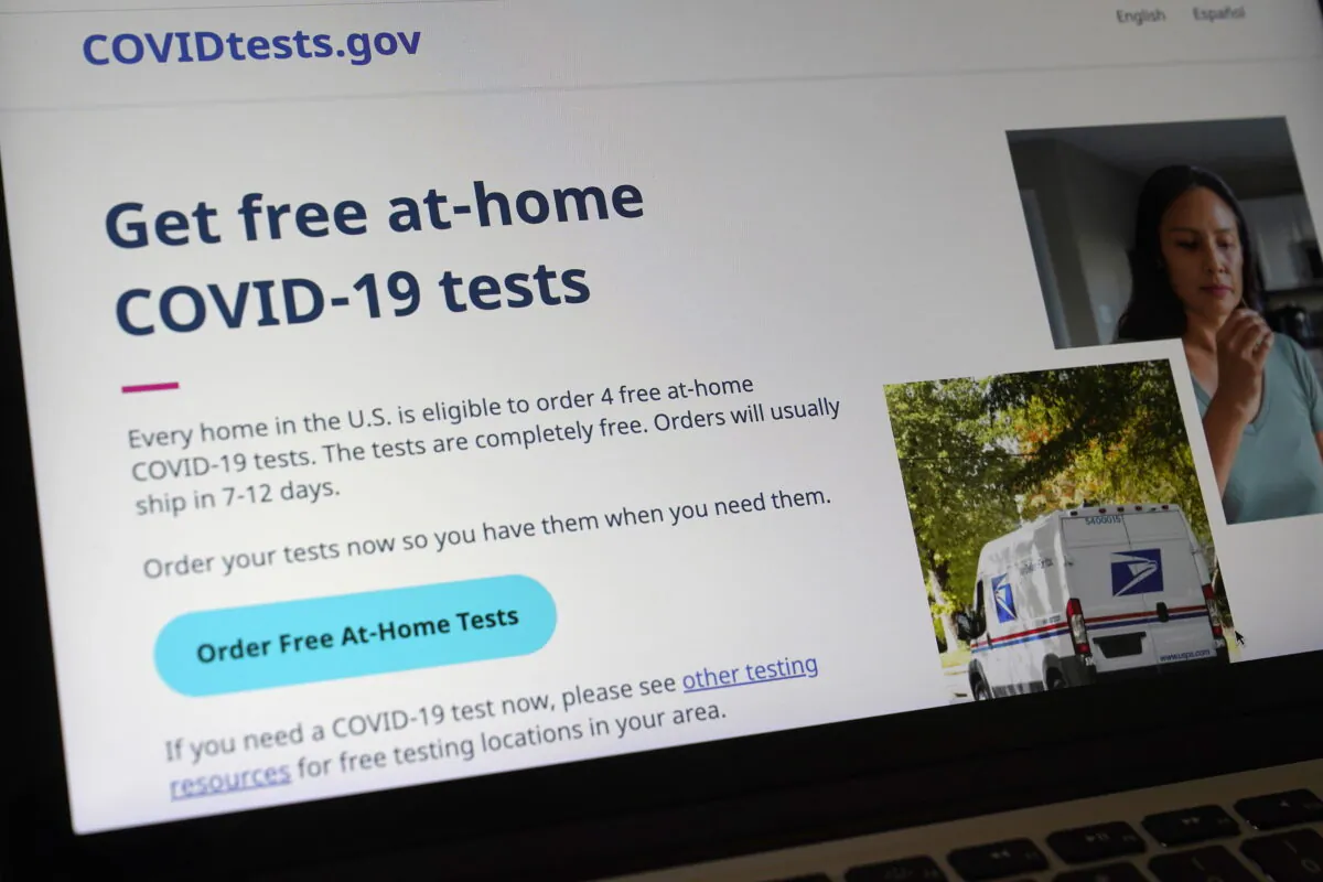 A U.S. government website that features a page where people can order free, at-home COVID-19 tests, is displayed on a computer in Walpole, Mass., on Jan. 19, 2022. (Steven Senne/AP Photo)