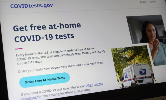 A U.S. government website that features a page where people can order free, at-home COVID-19 tests, is displayed on a computer in Walpole, Mass., on Jan. 19, 2022. (Steven Senne/AP Photo)