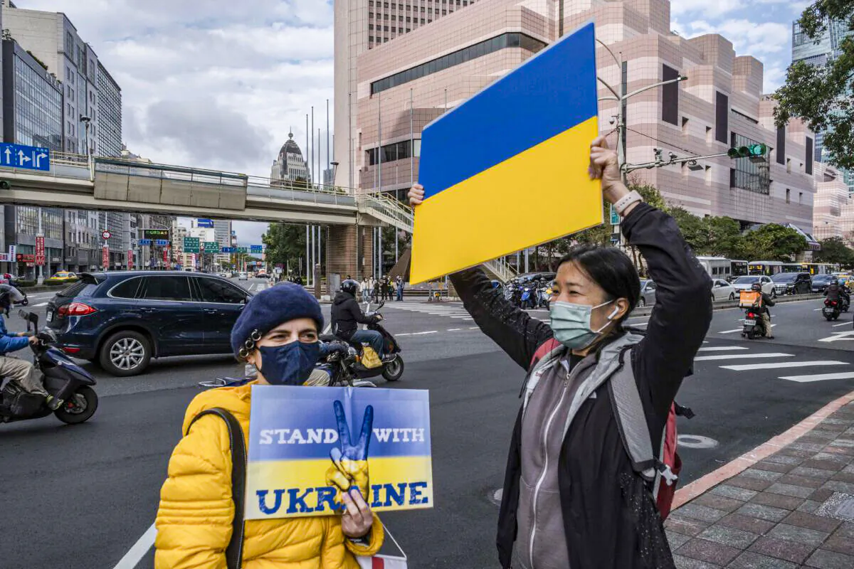Protesters display placards in front of the Representative Office of the Moscow-Taipei Coordination Commission in Taipei on Feb. 25, 2022, to protest against Russia's military invasion of Ukraine. (Lam Yik Fei/Getty Images)