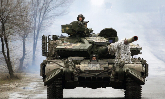 Ukrainian servicemen ride on tanks towards the front line with Russian forces in the Lugansk region of Ukraine on Feb. 25, 2022. (Anatolii Stepanov/AFP via Getty Images)