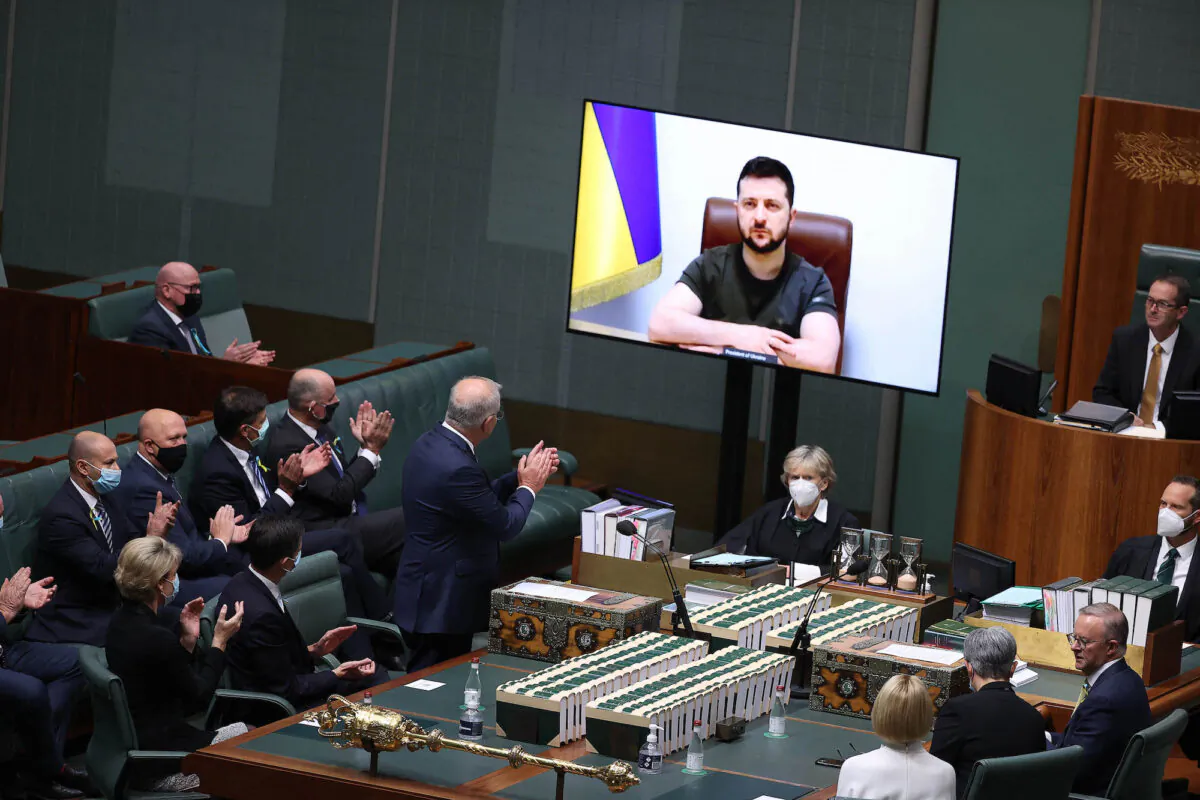 Ukrainian President Volodymyr Zelenskyy (on screen) addresses the Australian Parliament in the House of Representatives chamber via a video link in Canberra, Australia, on March 31, 2022. (Stringer/AFP via Getty Images)