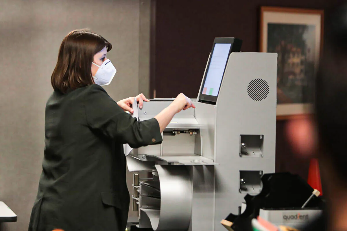 A file photo shows an election worker collecting the count from a voting machine in a file photo of the Nov. 3 election (Scott Olson/Getty Images)
