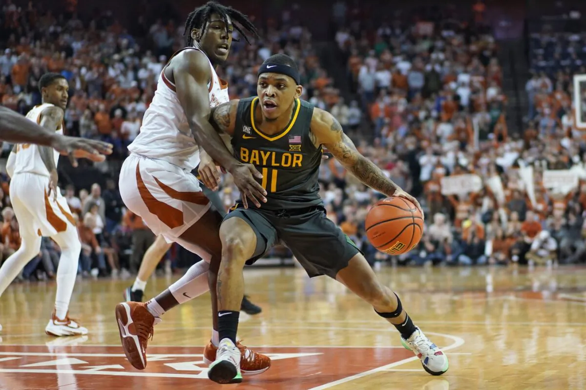 Baylor Bears guard James Akinjo (11) drives to the basket while defended by Texas Longhorns guard Marcus Carr (2) during the second half at Frank C. Erwin Jr. Center in Austin, Texas, on Feb. 28, 2022. (Scott Wachter/USA TODAY Sports via Field Level Media)