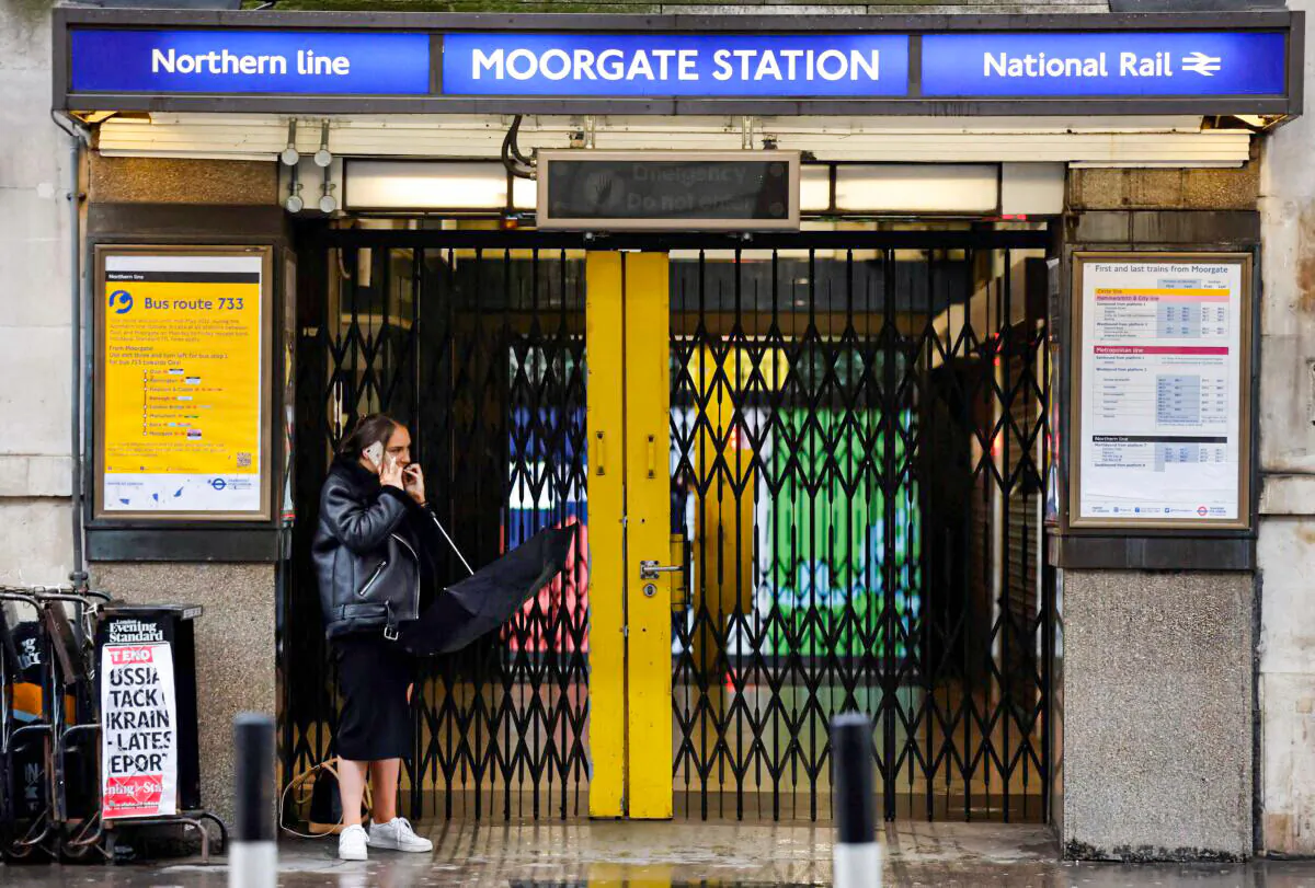 A pedestrian stands outside the shuttered entrance to the closed Moorgate Station in London on March 1, 2022. (Tolga Akmen/AFP via Getty Images)