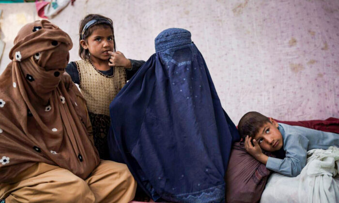Malalai (C) from Kunduz province, sits with her children at a camp for internally displaced people as they wait for a bus to return home, in Kabul, Afghanistan, on Oct. 9, 2021. (Felipe Dana/AP Photo)