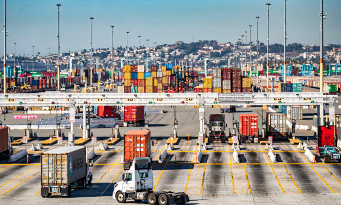 Trucks loaded with shipping containers prepare to leave the Port of Long Beach, Calif., on Oct 27, 2021. (John Fredricks/The Epoch Times)