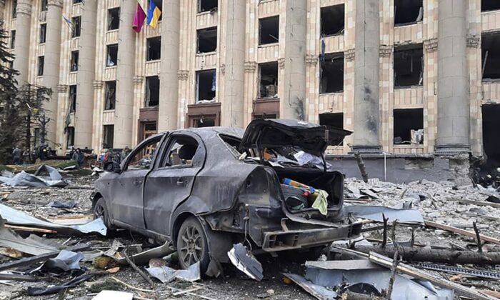 A burnt car is seen in front of a damaged City Hall building, in Kharkiv, Ukraine, on March 1, 2022. (Ukrainian Emergency Service via AP)