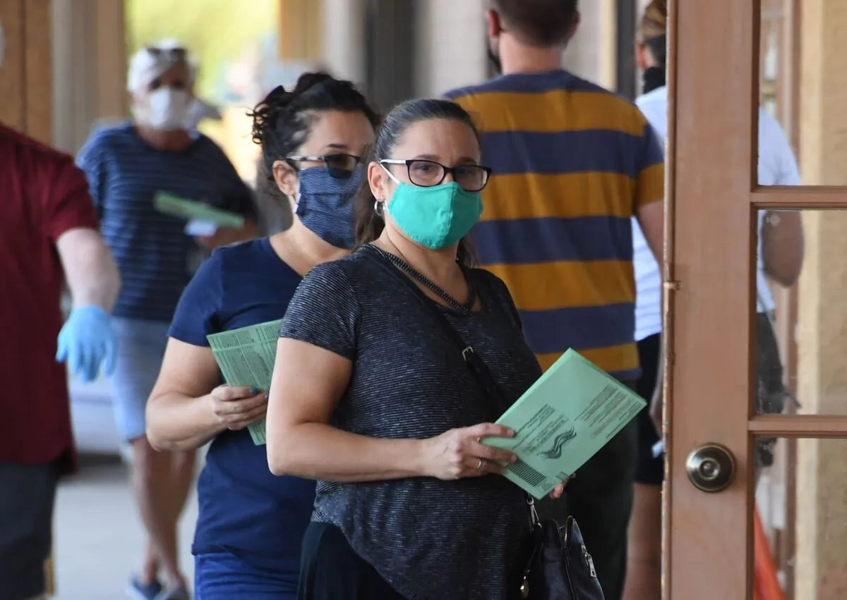 People wait in line to drop off mail-in ballots in a file photo. (Robyn Beck/AFP via Getty Images)
