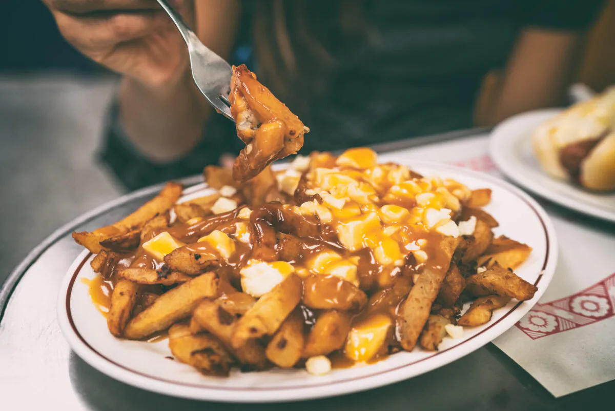 Diners eat poutine in Quebec in an undated photo. (Shutterstock)