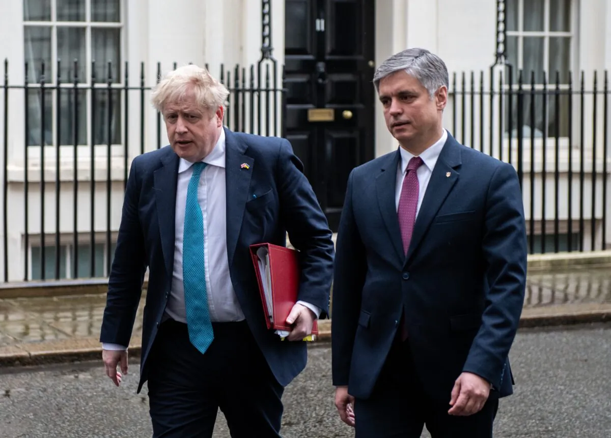 British Prime Minister Boris Johnson (L) and Ukrainian ambassador to the UK Vadym Prystaiko (R) leave Downing Street together to attend Prime Minister’s Questions at the Houses of Parliament in London, on March 2, 2022. (Chris J Ratcliffe/Getty Images)