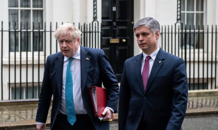 British Prime Minister Boris Johnson (L) and Ukrainian ambassador to the UK Vadym Prystaiko (R) leave Downing Street together to attend Prime Minister’s Questions at the Houses of Parliament in London, on March 2, 2022. (Chris J Ratcliffe/Getty Images)