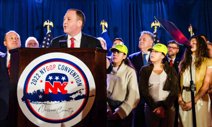 Rep. Lee Zeldin (R-N.Y.) accepts the nomination for governor at the New York State Republican Convention in Garden City, N.Y., on March 1, 2022, as his wife and daughters look on. (Dave Paone/The Epoch Times)