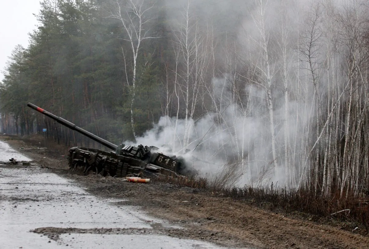 Smoke rises from a Russian tank destroyed by the Ukrainian forces on the side of a road in Lugansk region on Feb. 26, 2022. (Anatolii Stepanov / AFP via Getty Images)