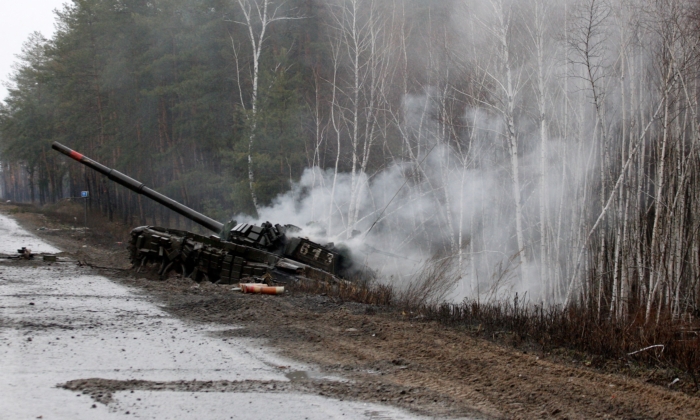 Smoke rises from a Russian tank destroyed by the Ukrainian forces on the side of a road in Lugansk region on Feb. 26, 2022. (Anatolii Stepanov / AFP via Getty Images)