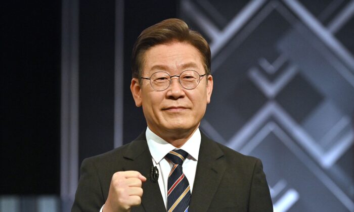 South Korea's presidential candidate Lee Jae-myung of the ruling Democratic Party poses for a photo before a televised debate for the upcoming March 9 presidential election at KBS studio in Seoul on March 2, 2022. (Photo by JUNG YEON-JE/POOL/AFP via Getty Images)