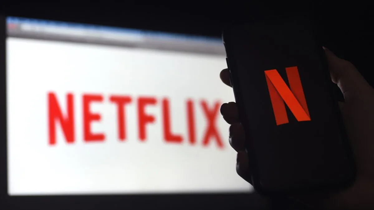 In this photo illustration a computer and a mobile phone screen display the Netflix logo  in Arlington, Va., on March 31, 2020. (Olivier Douliery/AFP via Getty Images)