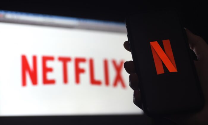In this photo illustration a computer and a mobile phone screen display the Netflix logo in Arlington, Virginia, on March 31, 2020. (Olivier Douliery/AFP via Getty Images)