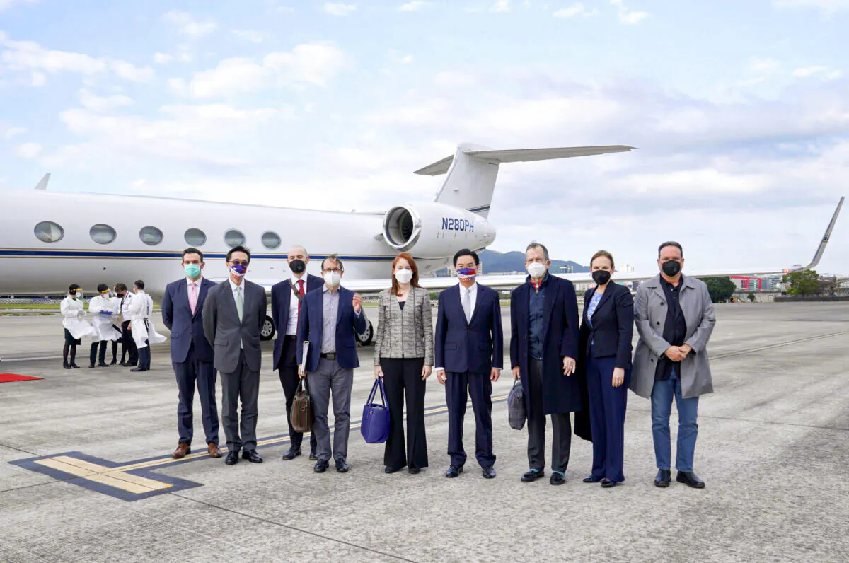 Taiwan's Foreign Minister Joseph Wu (4th R) stands with a U.S. delegation including retired Admiral Mike Mullen (3rd R), former chair of the Joint Chiefs of Staff, as they arrive at Taipei Songshan Airport in Taiwan on March 1, 2022. (Taiwan Ministry of Foreign Affairs via AP)
