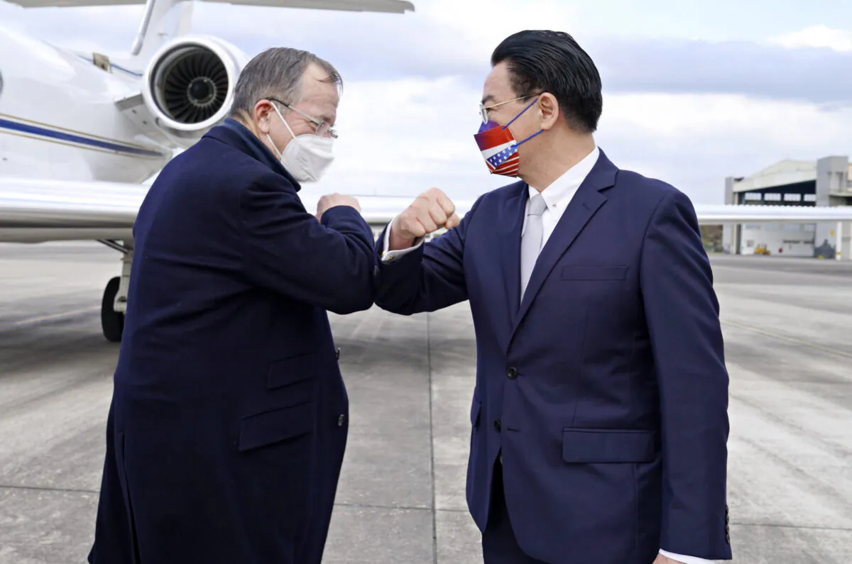 Taiwan's Foreign Minister Joseph Wu (R) greets former Chairman of the Joint Chiefs Admiral Mike Mullen as the latter arrives at Taipei Songshan Airport in Taiwan on March 1, 2022. (Taiwan Ministry of Foreign Affairs via AP)