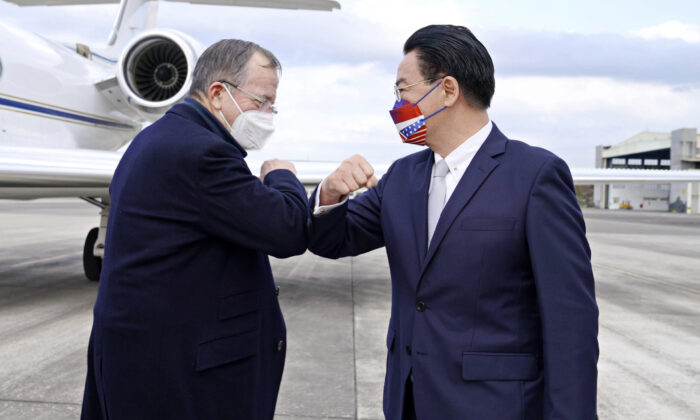 Taiwan's Foreign Minister Joseph Wu (R) greets former Chairman of the Joint Chiefs Admiral Mike Mullen as the latter arrives at Taipei Songshan Airport in Taiwan on March 1, 2022. (Taiwan Ministry of Foreign Affairs via AP)