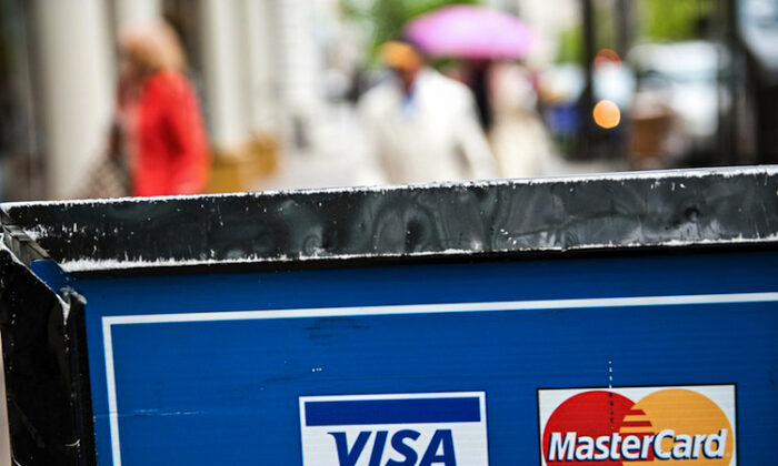 Visa and MasterCard credit card logos are seen on a sign in Washington on March 30, 2012. (Nicholas Kamm/AFP/Getty Images) 