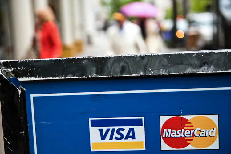Visa and MasterCard credit card logos are seen on a sign in Washington on March 30, 2012. (Nicholas Kamm/AFP/Getty Images)