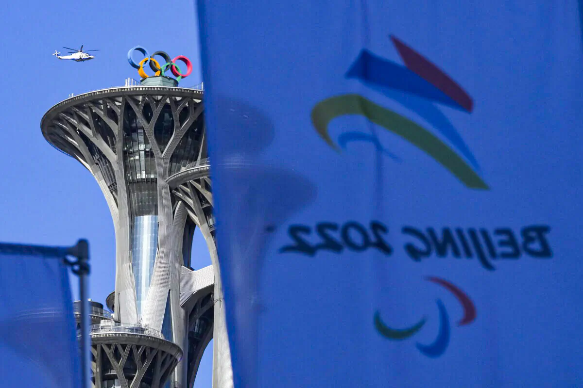 A helicopter flies past the Beijing Olympic Tower ahead of the 2022 Winter Paralympics in Beijing, on March 2, 2022. (Andy Wong/AP Photo)