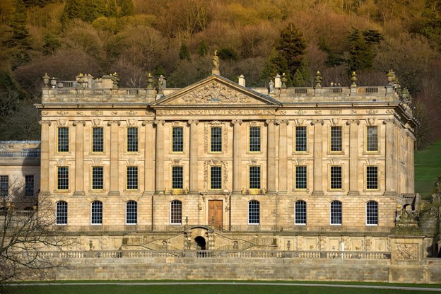 The main west façade was the original front entrance. A rhythm of Ionic pilasters and columns are centered around the pediment, the triangular roof element. It's believed to have been a collaboration of the first duke and architect Thomas Archer, who had taken the Grand Tour and was inspired by Italian Baroque architects. (Chatsworth House Trust)