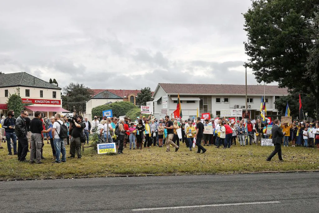 People attend a protest against Russia's invasion of Ukraine, outside the Russian embassy in Canberra, Australia, on Feb. 26, 2022. (Stringer/AFP via Getty Images)